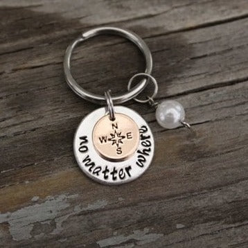 silver colored no matter where keychain with bronze colored compass charm overlaid